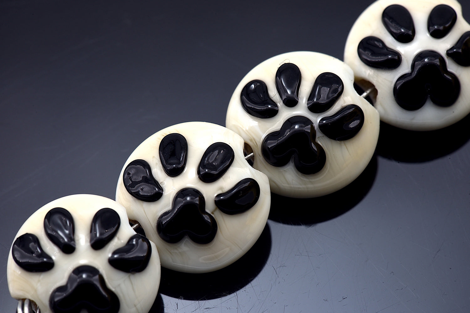 10306512- Four paw print Lentil Beads