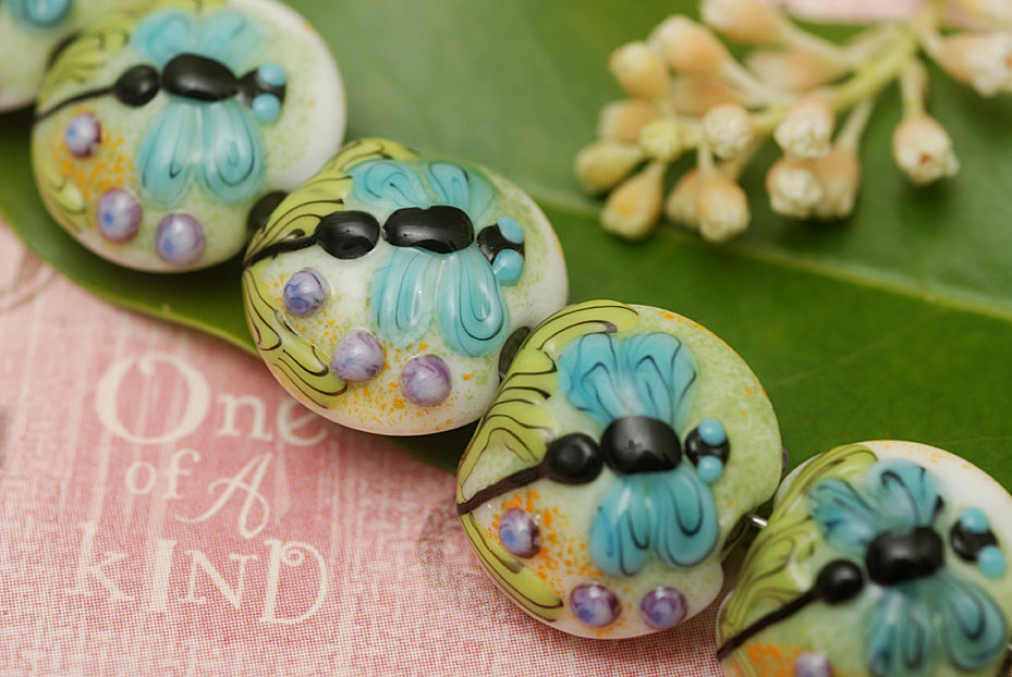 10504602 - Seven Blue Dragonfly Lentil Beads