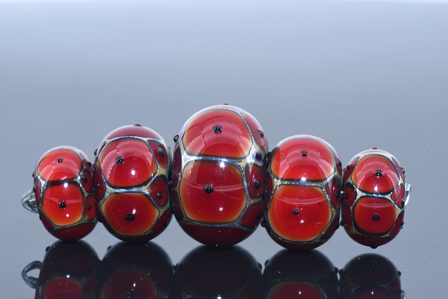 10703901 - Five Graduated Red w/Black Dots Rondelle Beads