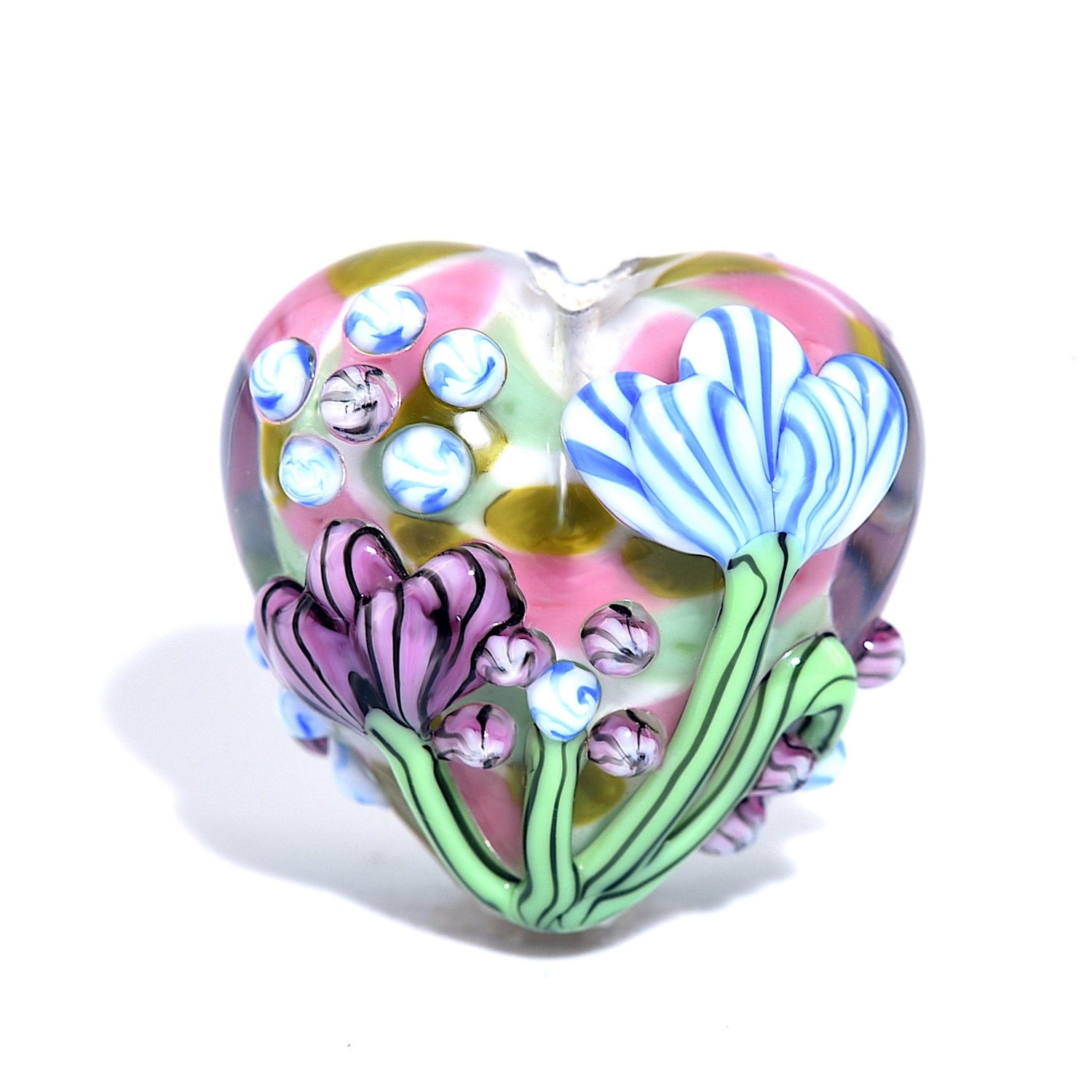 Heart-shaped glass ornament with floral designs on a white background