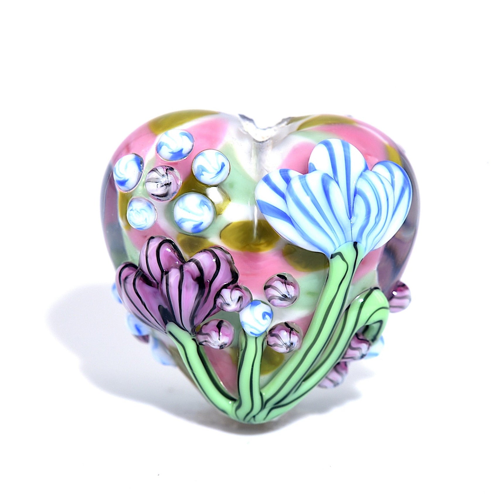 Heart-shaped glass ornament with floral designs on a white background