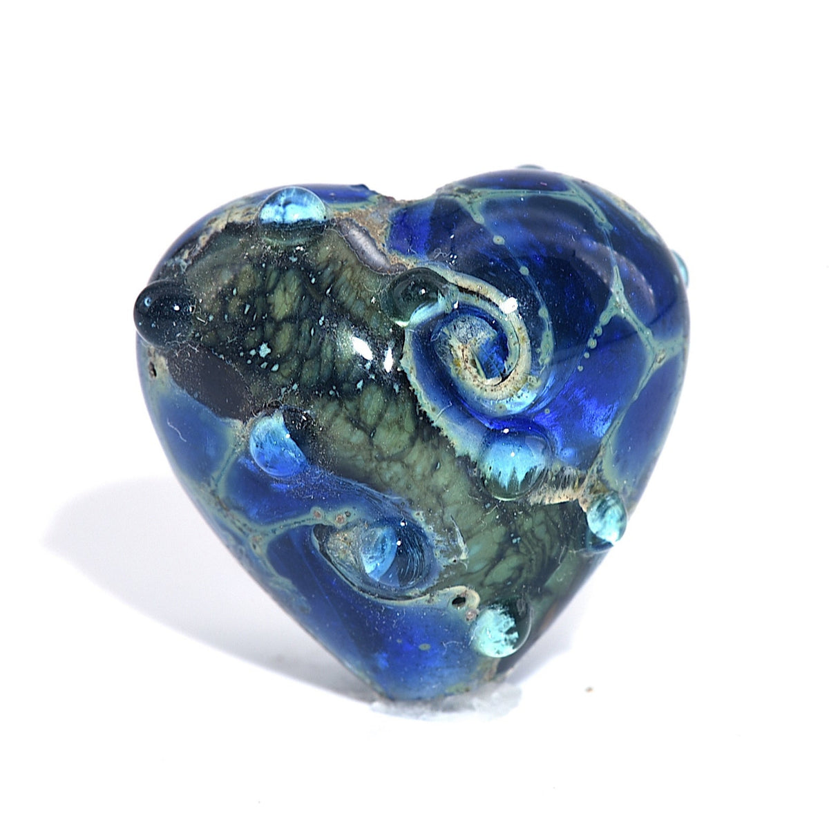 Heart-shaped blue and green glass bead on a white background
