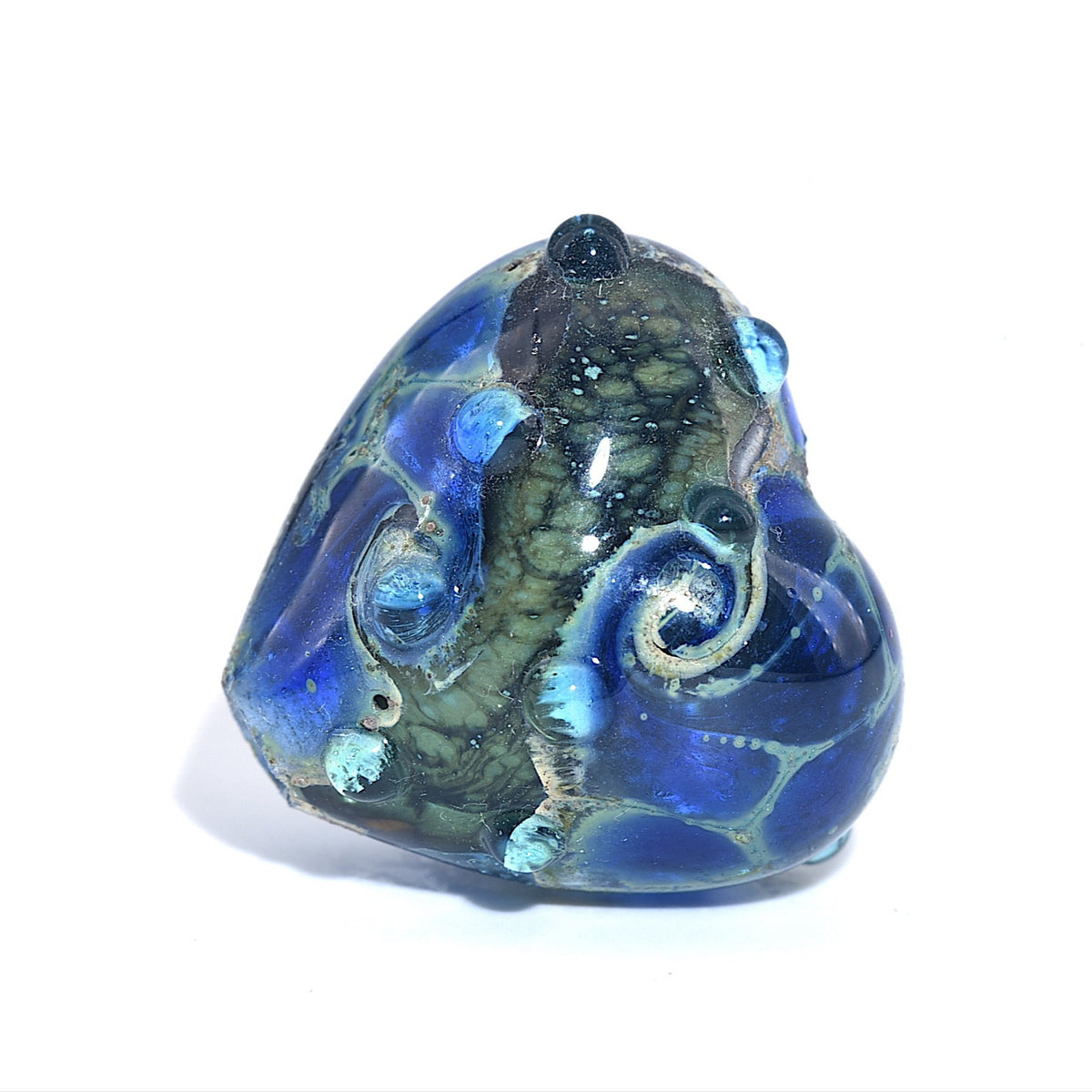 Glass sculpture of an octopus with blue and green colors on a white background