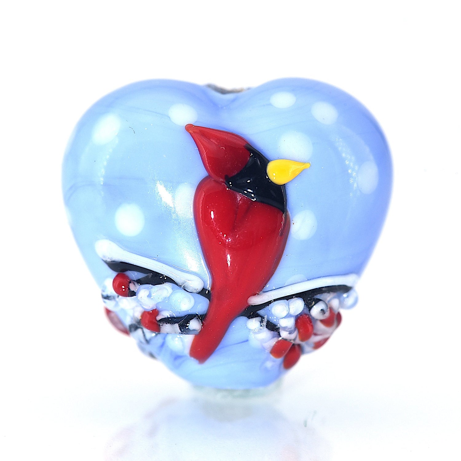 Heart-shaped object with a red bird design on a white background