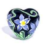Heart-shaped object with floral design on a white background