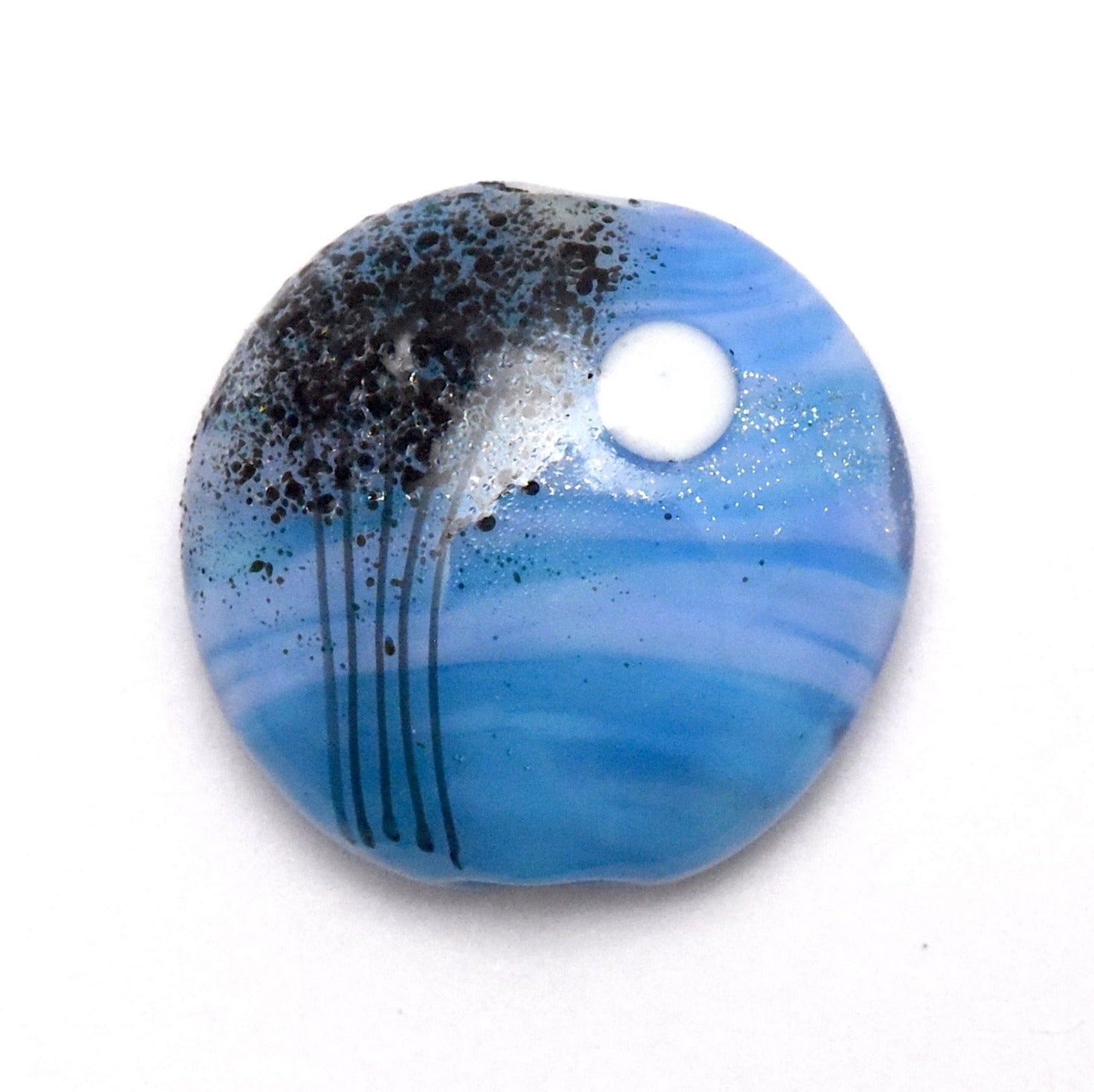 Round blue and black decorative item on a white background
