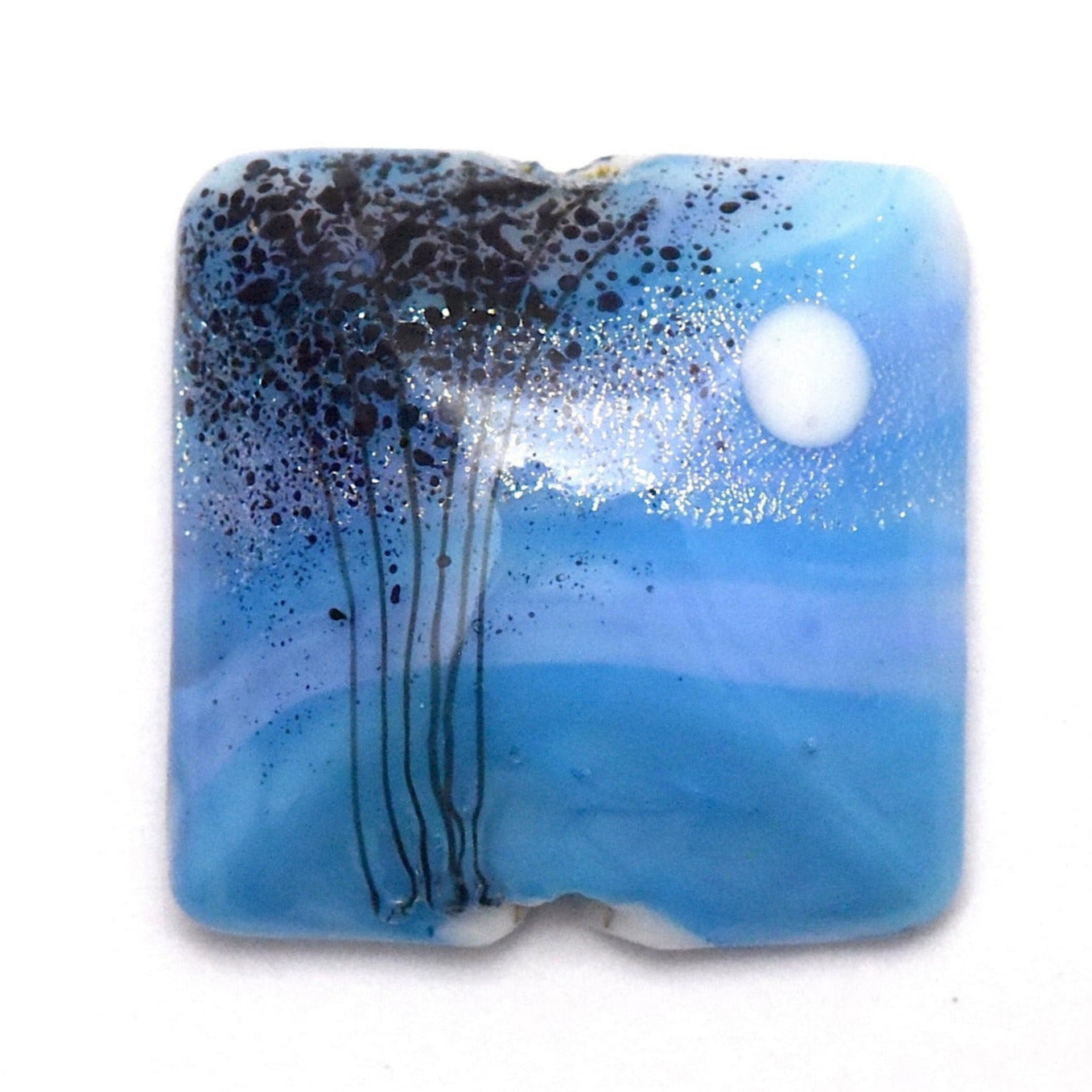 Square glass pendant with blue and black design on a white background