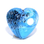 Blue heart-shaped object with black speckles on a white background