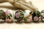 10107501 - Seven Black/White w/Flower & Leaf Rondelle Beads