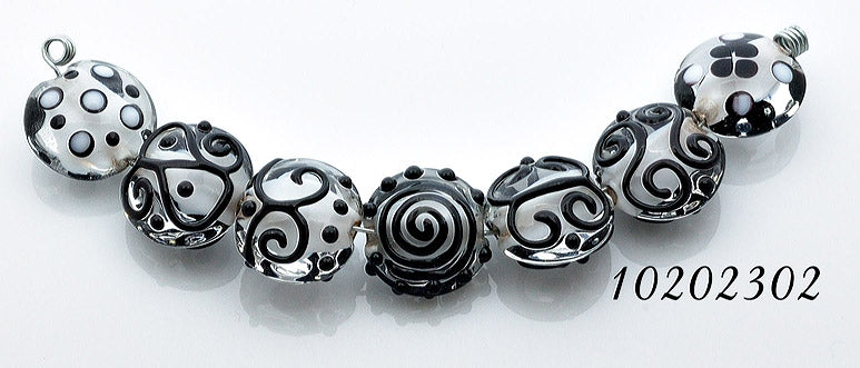 10202302 - Seven Black & White Lentil Beads