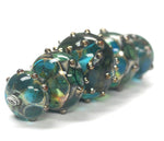 10406711 - Five Graduated Ocean Blue w/Silver Foil Beads