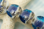 10407112 - Four Transparent Blue Seashell Lentil Beads
