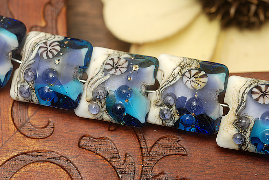 10407104 - Seven Transparent Blue Seashell Pillow Beads