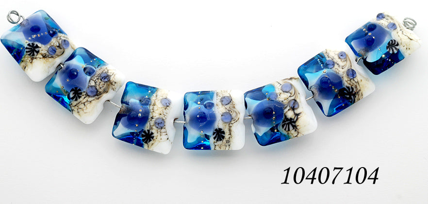 10407104 - Seven Transparent Blue Seashell Pillow Beads