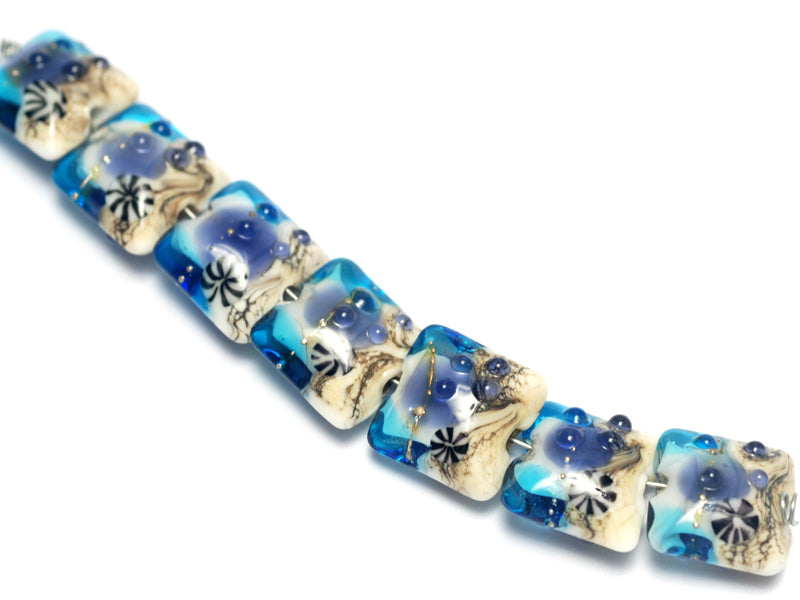 10407104 - Seven Transparent Blue Seashell Pillow Beads