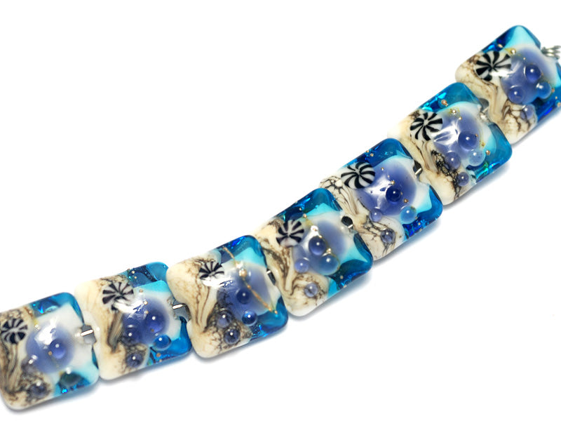 10407104 - Seven Transparent Blue Seashell Pillow Beads