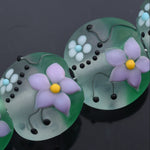 Decorative buttons with floral designs on a dark background