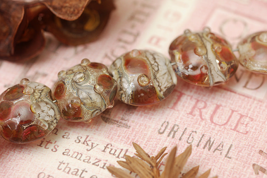 10703802 - Seven Transparent Red w/Silver Foil Lentil Beads