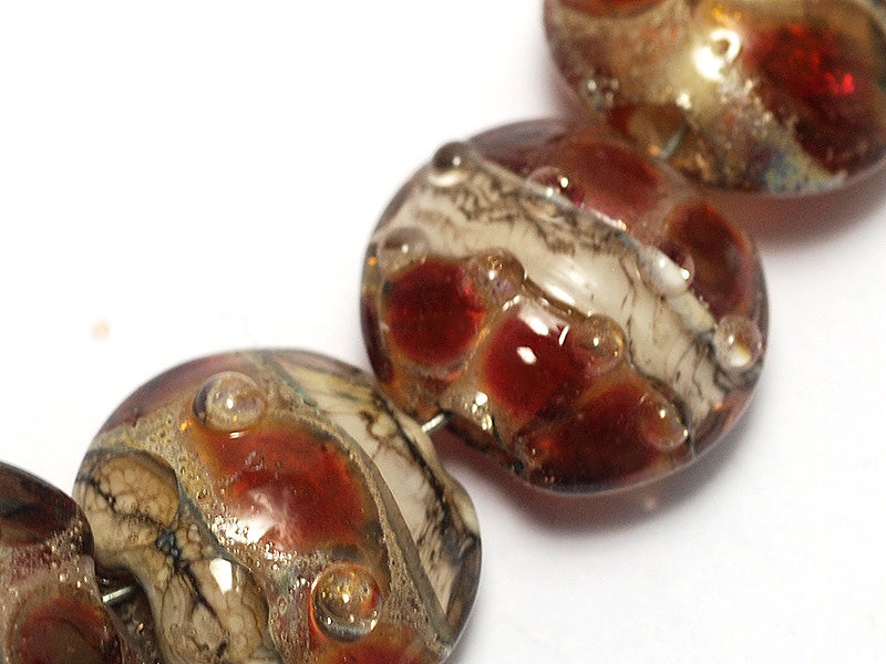 10703802 - Seven Transparent Red w/Silver Foil Lentil Beads
