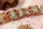 10703804 - Seven Transparent Red w/Silver Foil Pillow Beads
