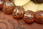 10704102 - Seven Orange Lentil Beads