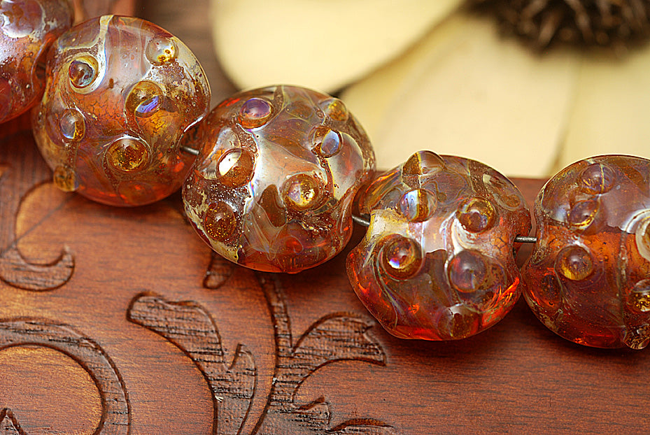 10704102 - Seven Orange Lentil Beads