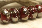 10704201 - Seven Regal Red Metallic Rondelle Beads