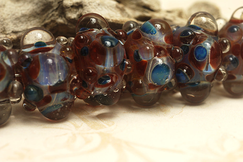 10704821 - Six Red w/Blue Rondelle Beads