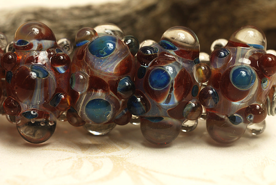 10704821 - Six Red w/Blue Rondelle Beads