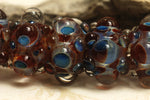 10704821 - Six Red w/Blue Rondelle Beads