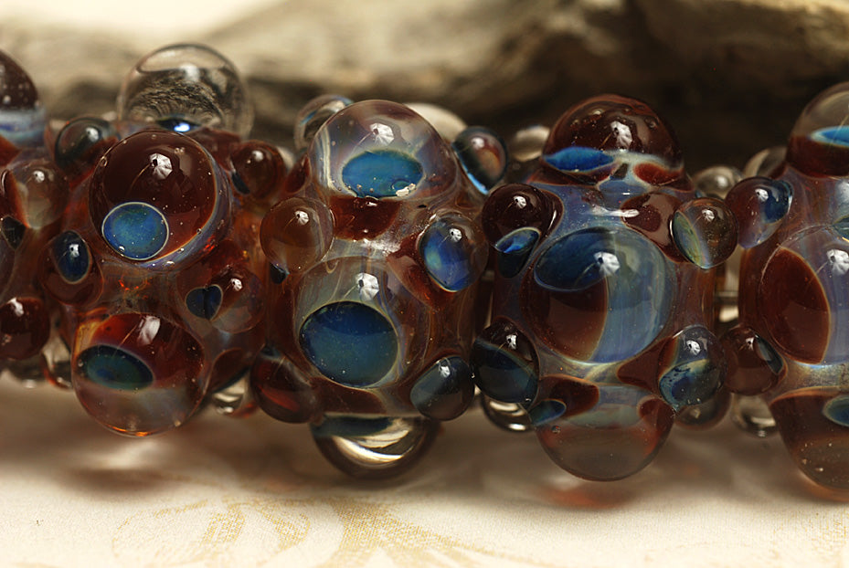 10704821 - Six Red w/Blue Rondelle Beads