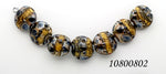 10800802 - Seven Black w/Yellow Silver Foil Lentil Beads