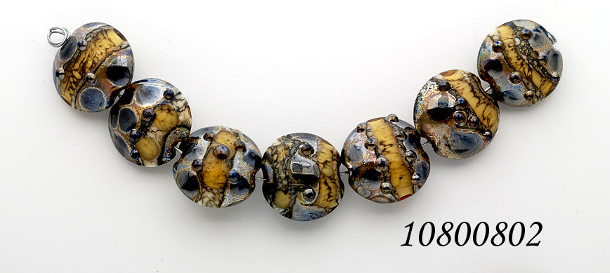 10800802 - Seven Black w/Yellow Silver Foil Lentil Beads