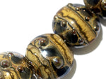 10800802 - Seven Black w/Yellow Silver Foil Lentil Beads