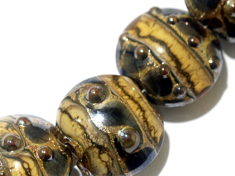 10800802 - Seven Black w/Yellow Silver Foil Lentil Beads