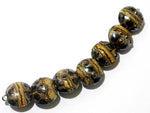 10800802 - Seven Black w/Yellow Silver Foil Lentil Beads