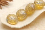 10801212 - Four Golden Yellow Metallic Lentil Beads