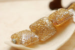 10801214 - Four Golden Yellow Metallic Pillow Beads