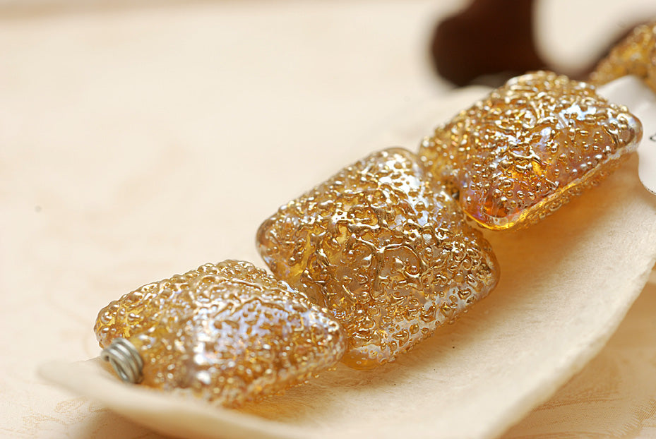 10801214 - Four Golden Yellow Metallic Pillow Beads