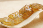 10801214 - Four Golden Yellow Metallic Pillow Beads