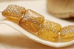 10801214 - Four Golden Yellow Metallic Pillow Beads