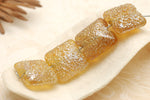 10801214 - Four Golden Yellow Metallic Pillow Beads