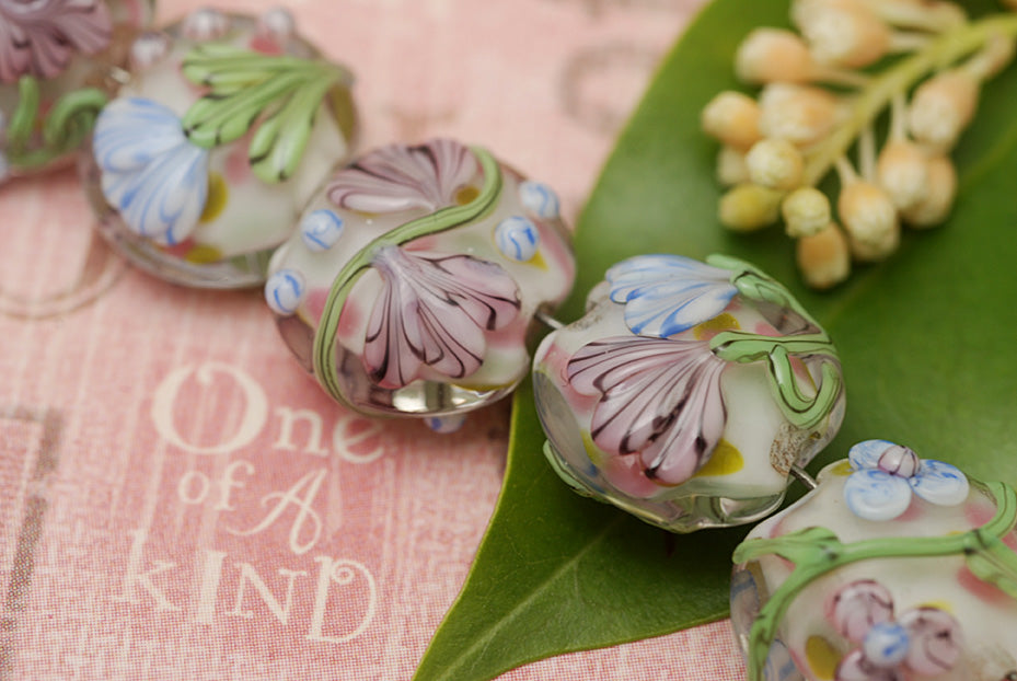 11005402 - Seven Light Pink w/Blue Floral Lentil Beads