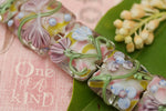11005404 - Seven Light Pink w/Blue Floral Pillow Beads