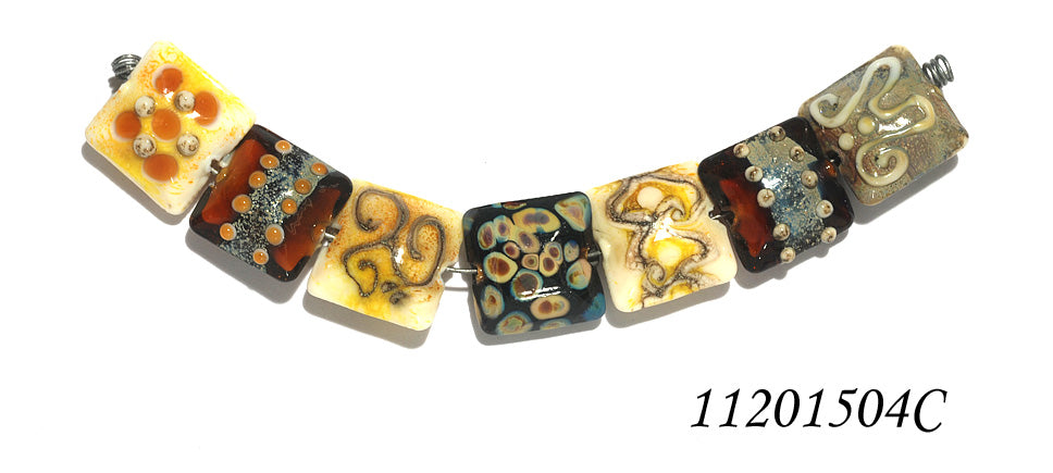 11201504C - Seven Dark Yellow w/Silver Stringers Pillow Beads