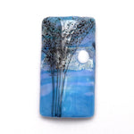 Decorative tile with tree design and moon on a blue background