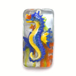 Colorful seahorse design on a rectangular glass tile with a white background
