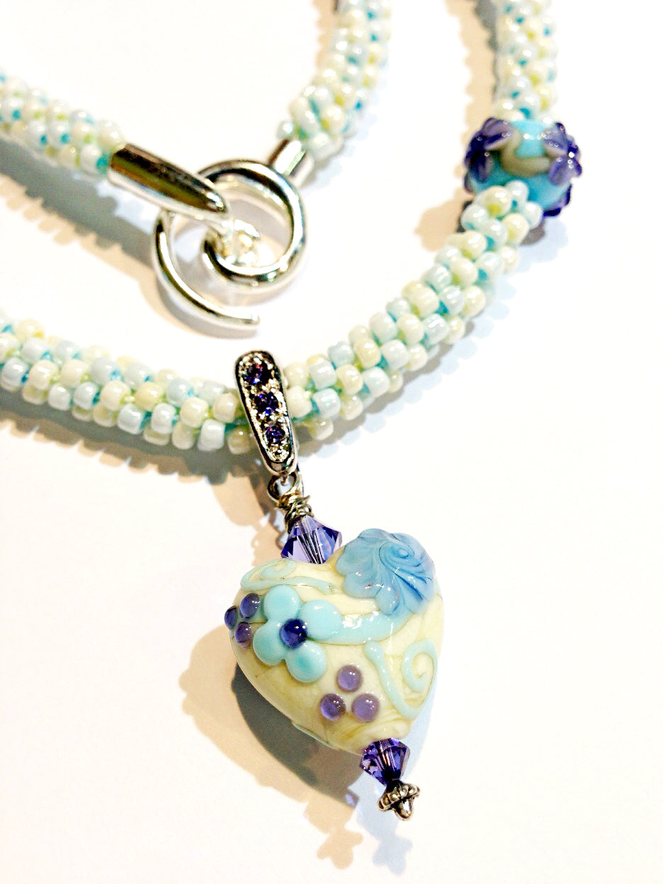 LC- Necklace with 11808305 Light Ivory w/Blue Flower Heart