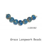 11203302 - Seven Ivory w/Blue Swirl Lentil Beads