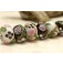 10107501 - Seven Black/White w/Flower & Leaf Rondelle Beads